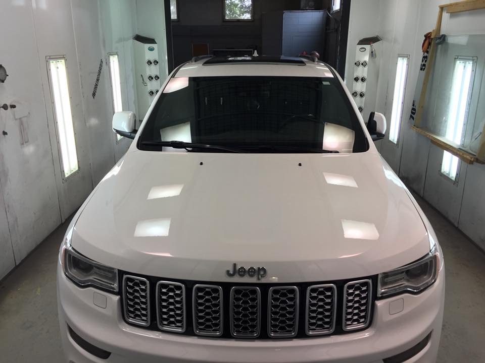 Detailed white Jeep Grand Cherokee in the shop