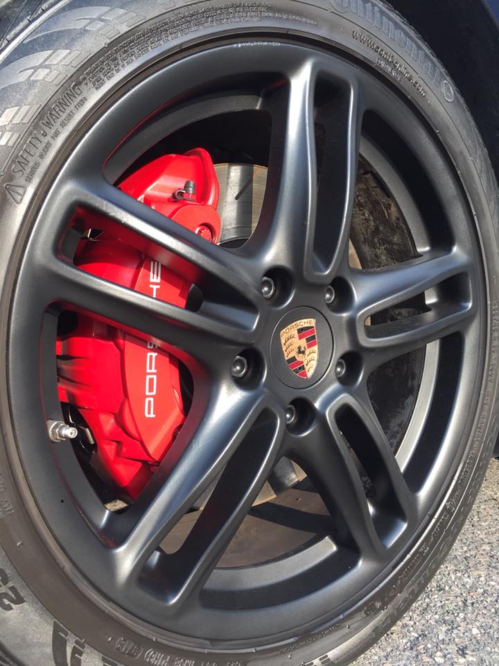 Porsche wheel with red caliper after detailing
