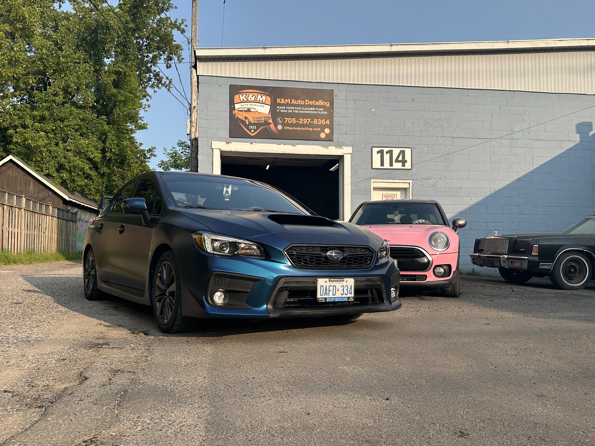 Sault Customs and Detailing storefront with vehicles